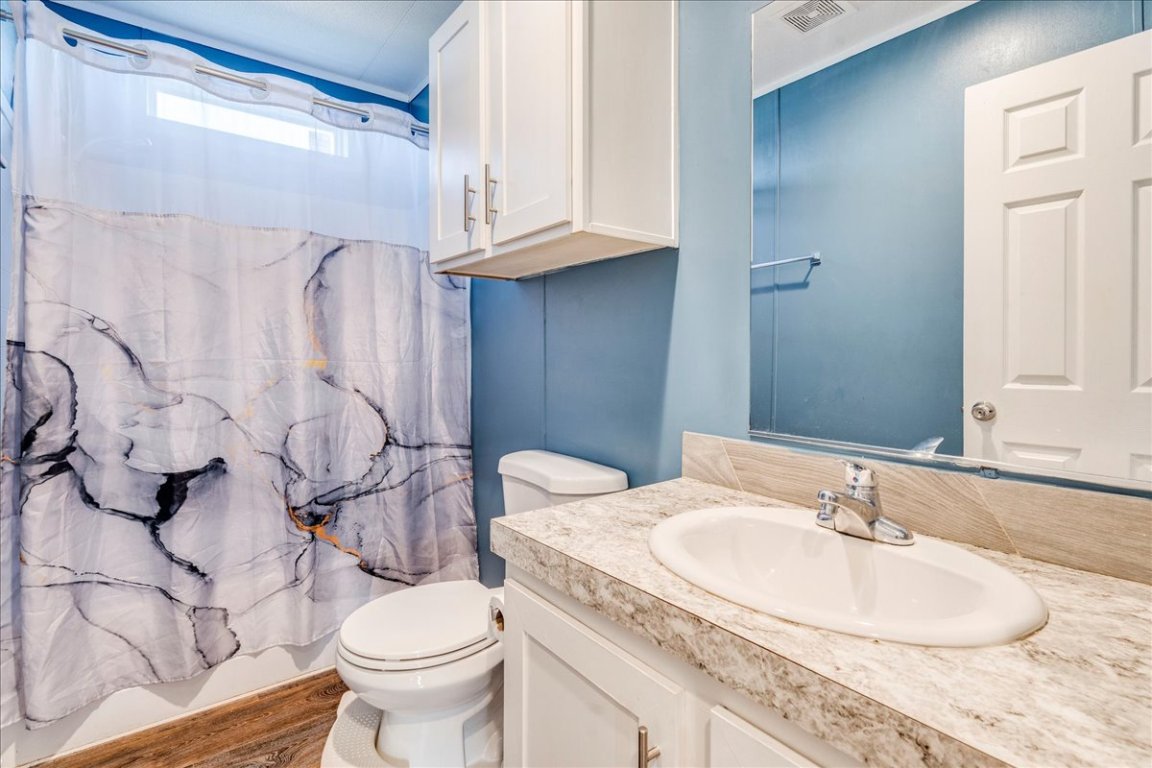 114 Gran Cielo Elgin, TX 78621 - Photo 19 of 40 a bathroom with a granite countertop sink and a toilet