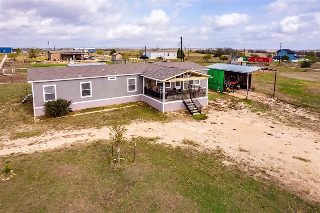 an aerial view of a house with a yard