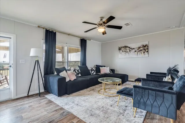 a living room with furniture and kitchen view