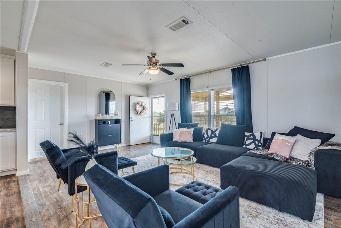 114 Gran Cielo Elgin, TX 78621 - Photo 5 of 40 a living room with furniture wooden floor and a window