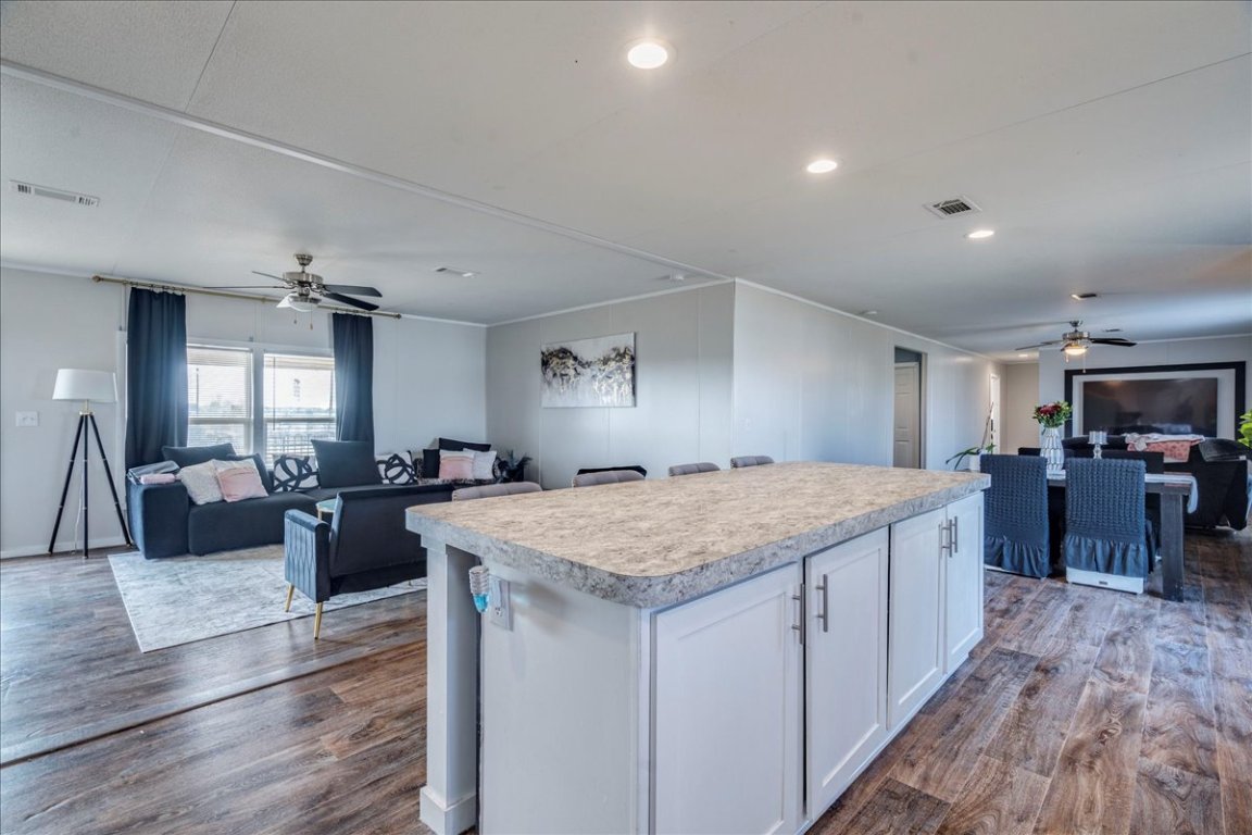 114 Gran Cielo Elgin, TX 78621 - Photo 7 of 40 a large kitchen with kitchen island a sink a counter space and stainless steel appliances