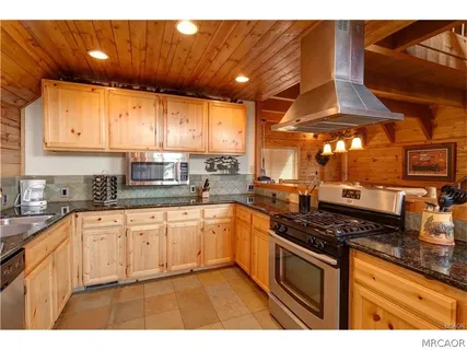 a kitchen with stainless steel appliances granite countertop a stove a sink and a granite counter tops