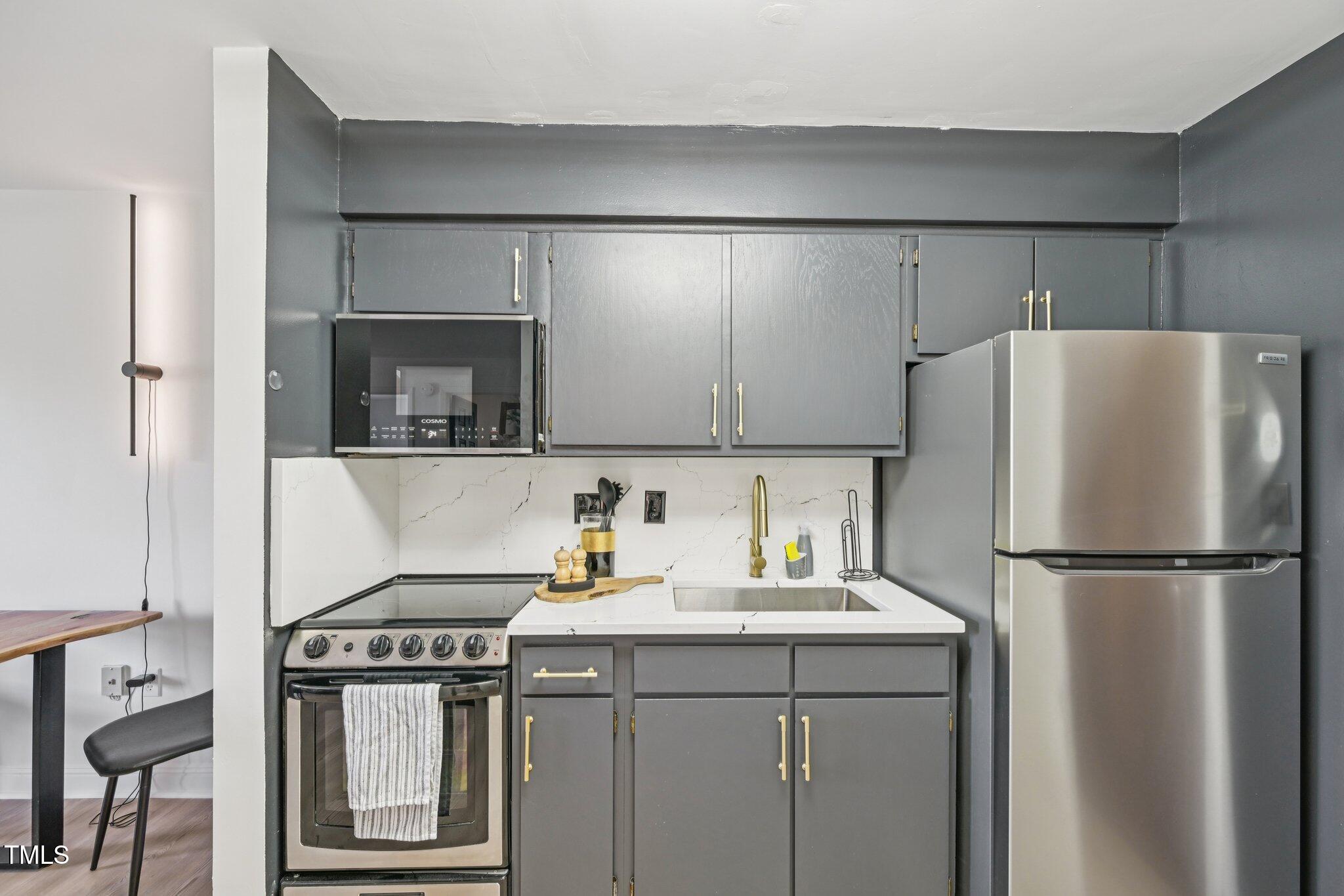 4700 Westgrove Street, Unit 721 Raleigh, NC 27606 - Photo 12 of 21 a kitchen with a refrigerator sink and cabinets