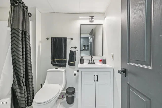 a white toilet sitting next to a bathroom sink
