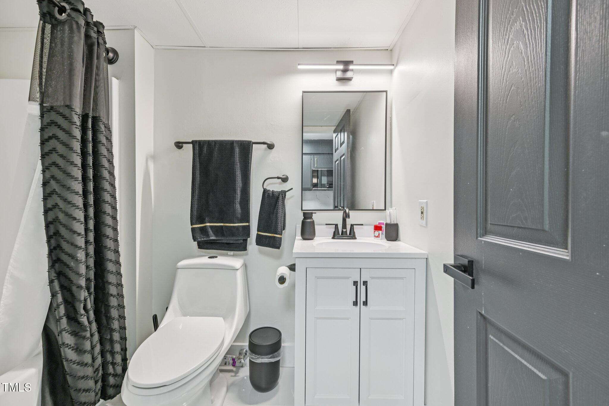 4700 Westgrove Street, Unit 721 Raleigh, NC 27606 - Photo 14 of 21 a white toilet sitting next to a bathroom sink