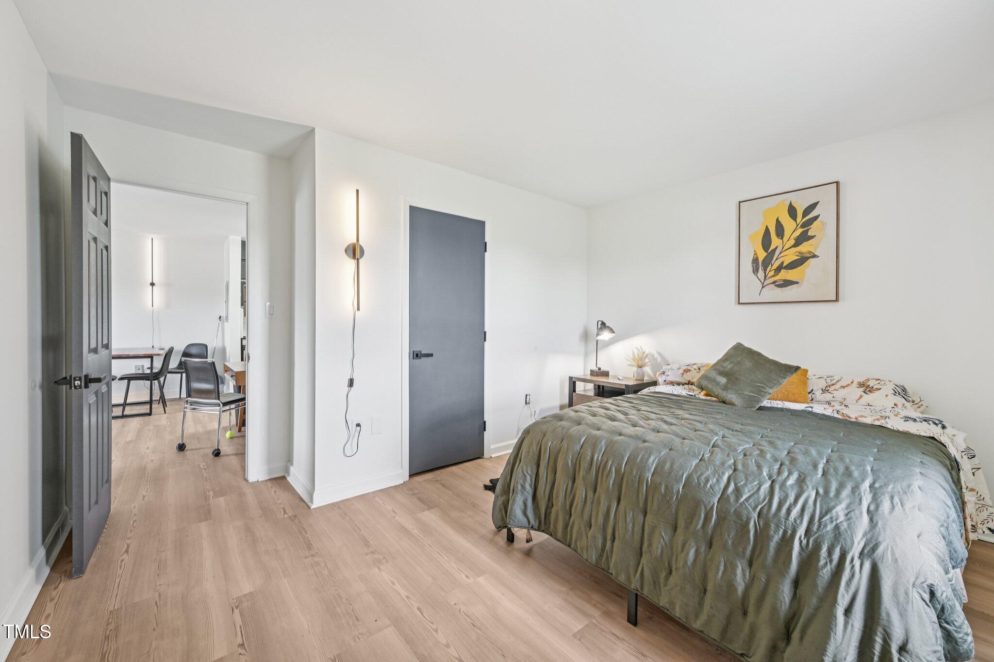 4700 Westgrove Street, Unit 721 Raleigh, NC 27606 - Photo 17 of 21 a bedroom with a bed and painting on the wall