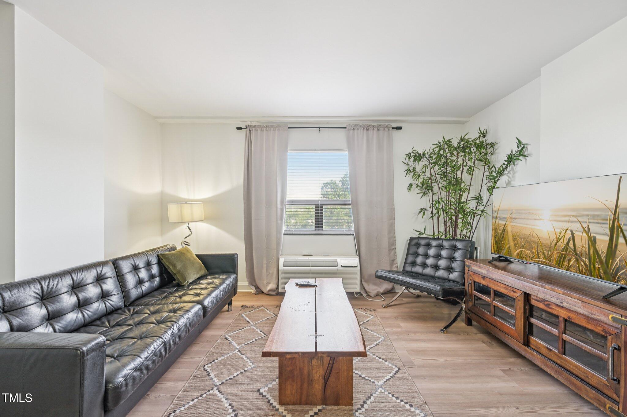 4700 Westgrove Street, Unit 721 Raleigh, NC 27606 - Photo 5 of 21 a living room with furniture and a flat screen tv