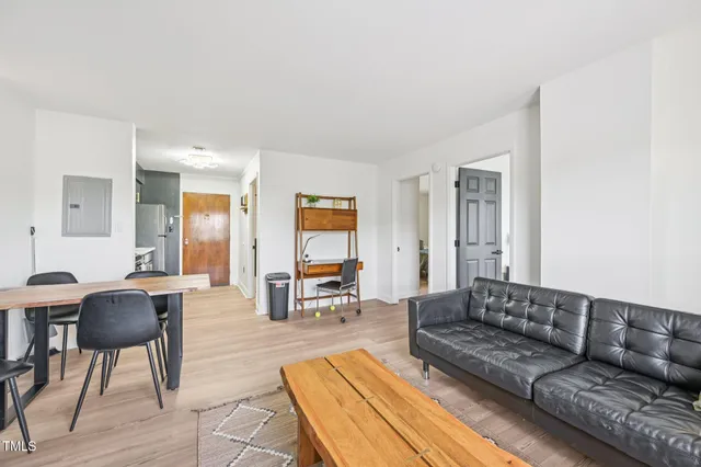 a living room with furniture and a dining table