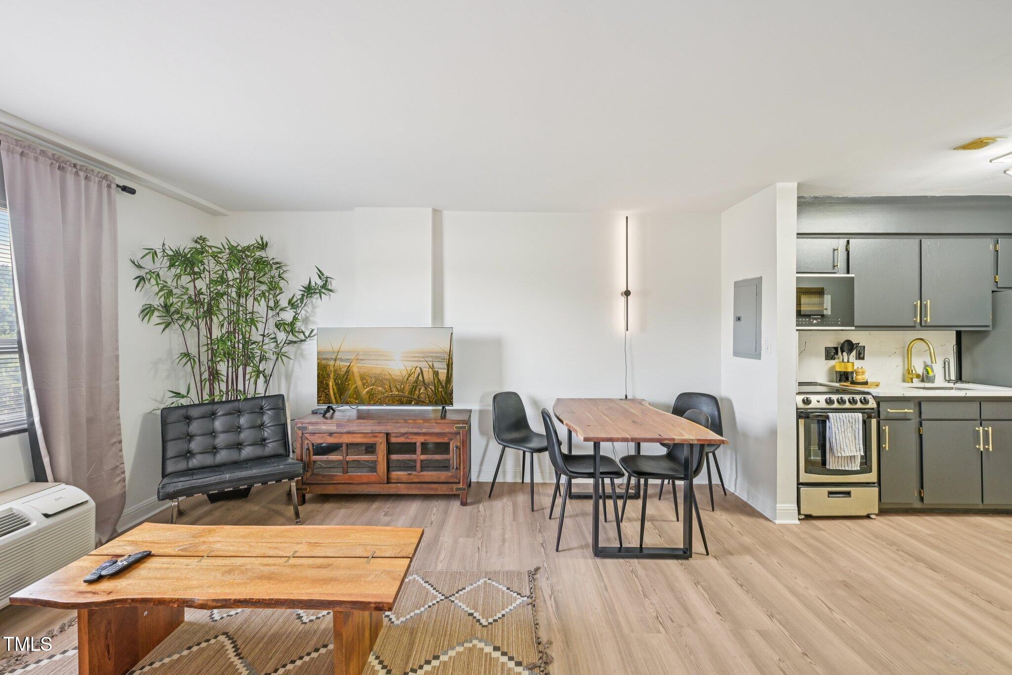 4700 Westgrove Street, Unit 721 Raleigh, NC 27606 - Photo 8 of 21 a view of a dining room with furniture and wooden floor