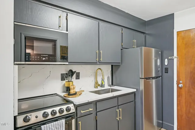 a kitchen with a refrigerator and a stove