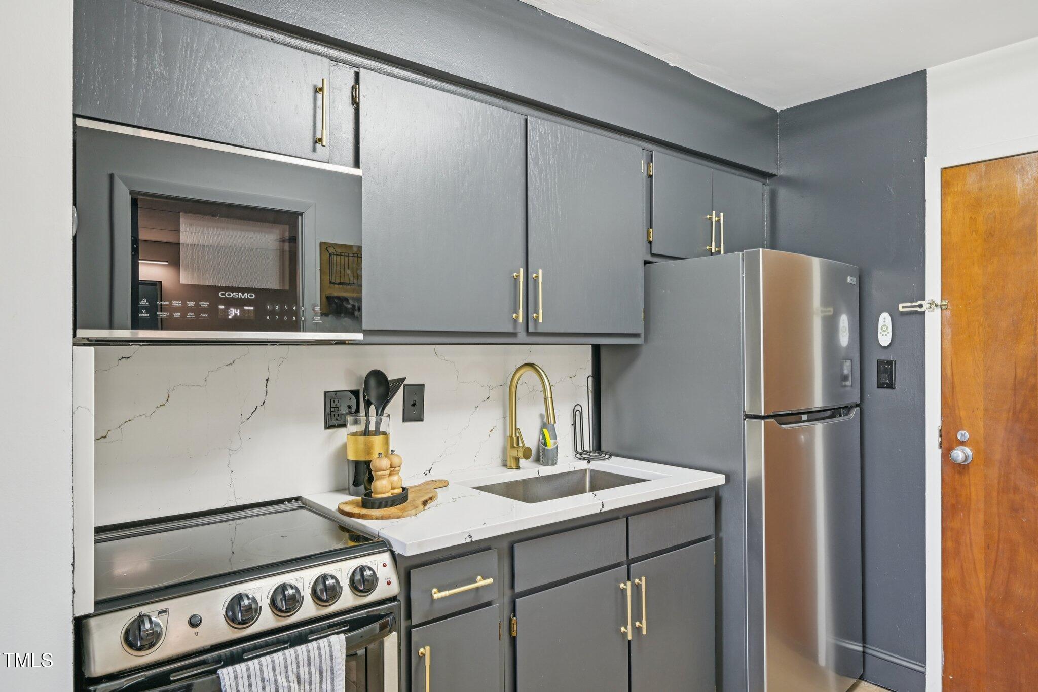 4700 Westgrove Street, Unit 721 Raleigh, NC 27606 - Photo 10 of 21 a kitchen with a refrigerator and a stove