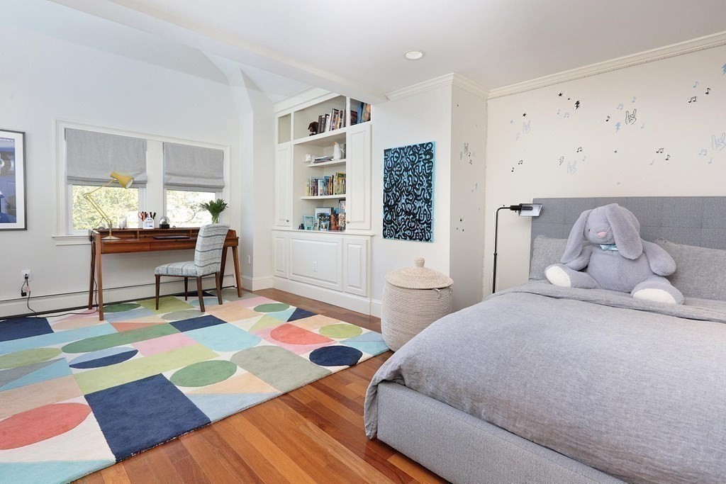16 Pilgrim Road Newton, MA 02468 - Photo 16 of 25 a bedroom with a bed and a table in it