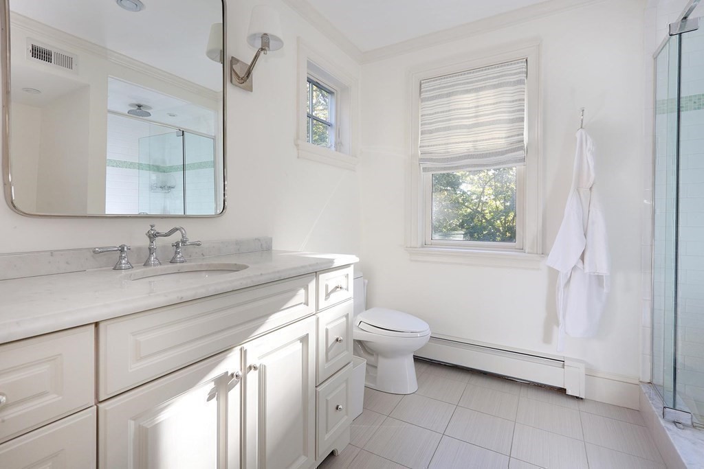 16 Pilgrim Road Newton, MA 02468 - Photo 19 of 25 a bathroom with a granite countertop sink a toilet and a mirror