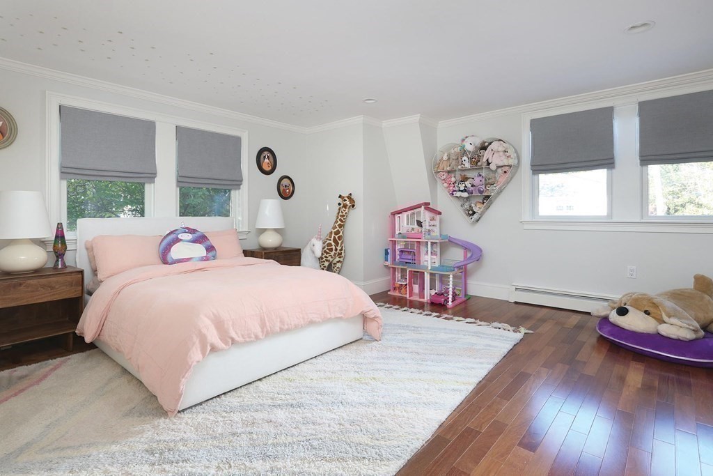16 Pilgrim Road Newton, MA 02468 - Photo 20 of 25 a bedroom with a bed and a table in it