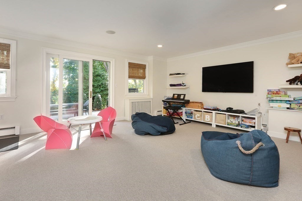 16 Pilgrim Road Newton, MA 02468 - Photo 22 of 25 a living room with furniture a flat screen tv and a large window