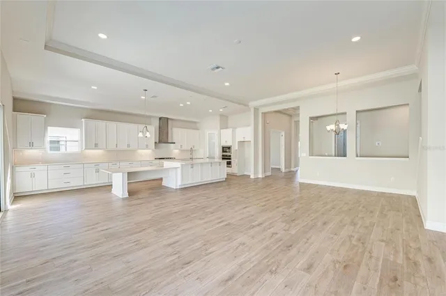 a view of a kitchen with kitchen island wooden floors wooden floor and center island