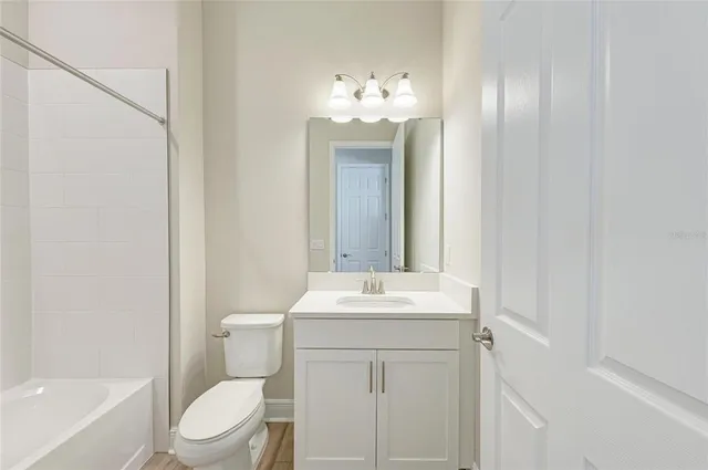 a bathroom with a toilet a sink and a mirror