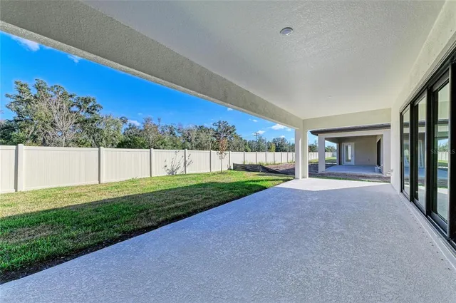 a view of an house with backyard space and a tree