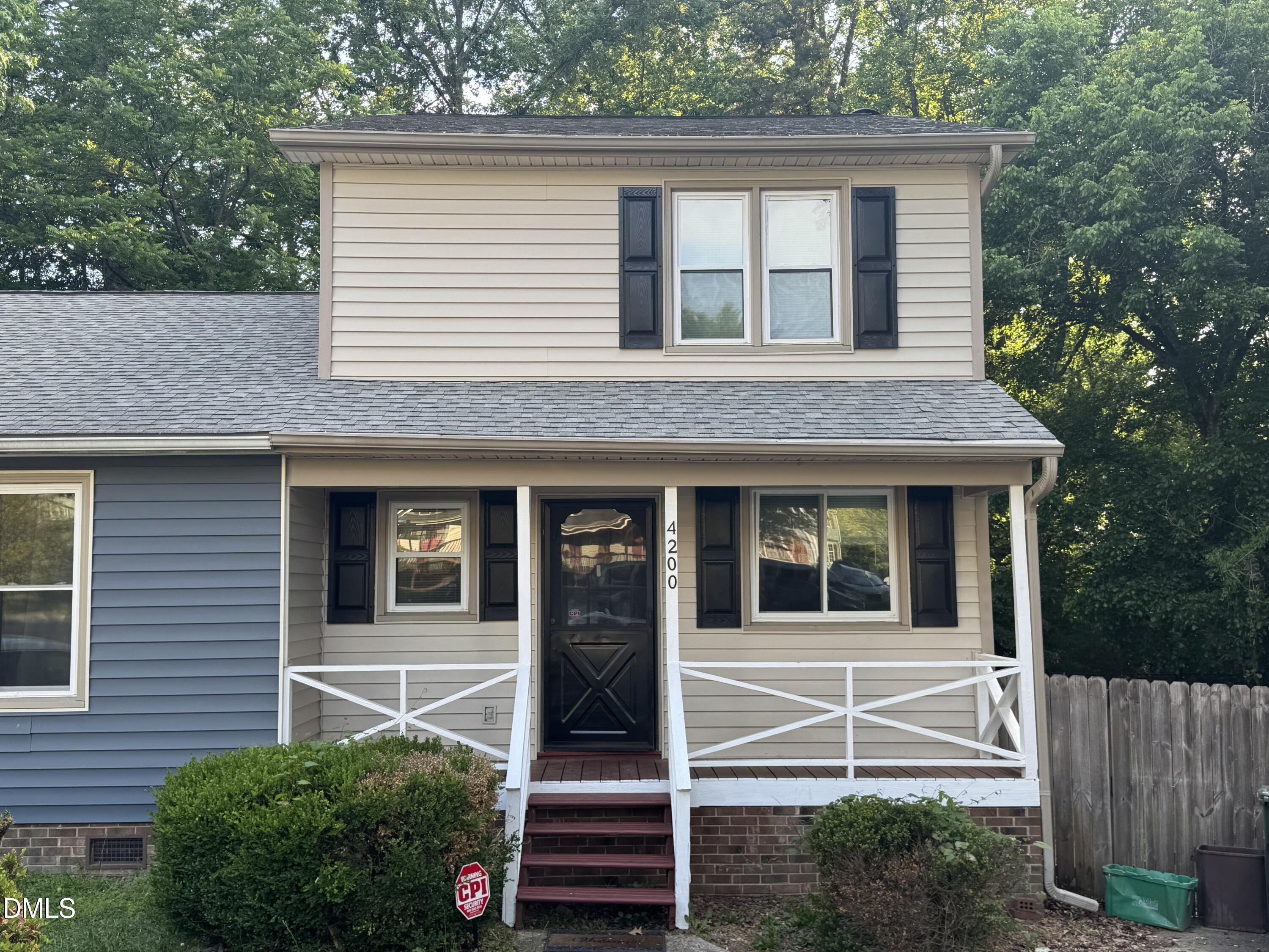 a view of brick house with a small yard