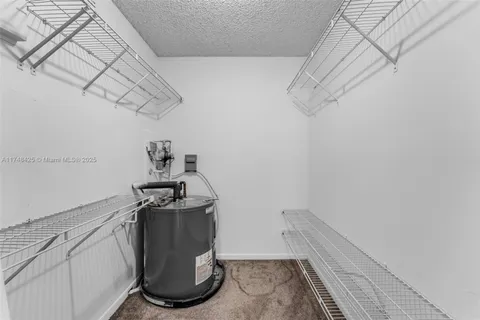 a room with water heater and storage racks