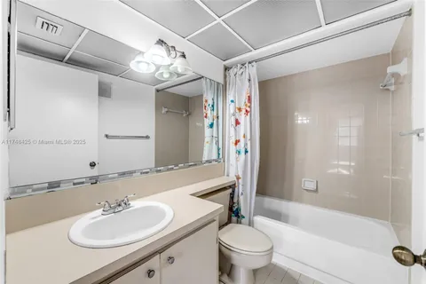 a bathroom with a sink double vanity granite tub and a mirror