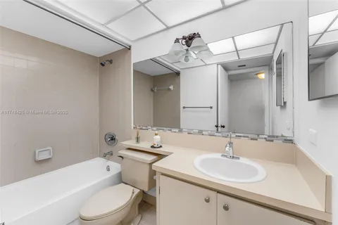 a bathroom with a sink toilet a mirror and shower