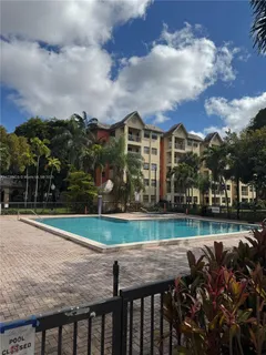 a view of a house next to a yard with big trees