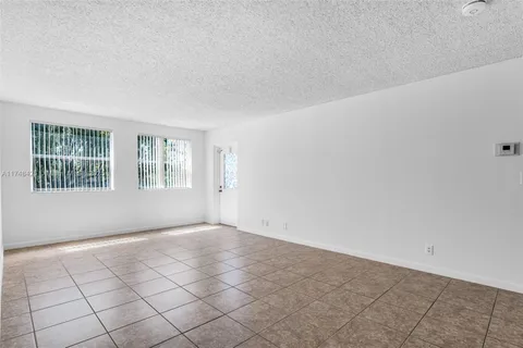 a view of an empty room with windows