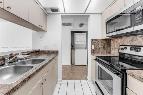 a kitchen with a sink cabinets and stainless steel appliances