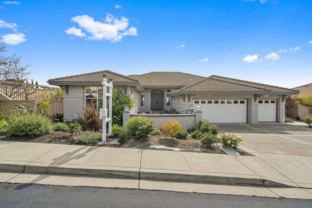 a front view of a house with a yard and a garage