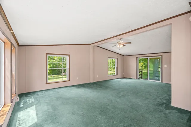 a spacious bedroom with a bed and a television