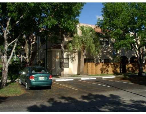 513 Racquet Club Road, Unit 55 Weston, FL 33326 - Photo 2 of 25 a car parked on the side of the road