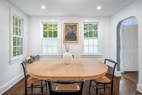 a view of a dining room with furniture window and wooden floor