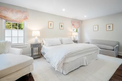 a bedroom with a large bed and a couch