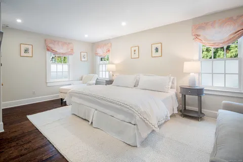 a spacious bedroom with a bed and a large window