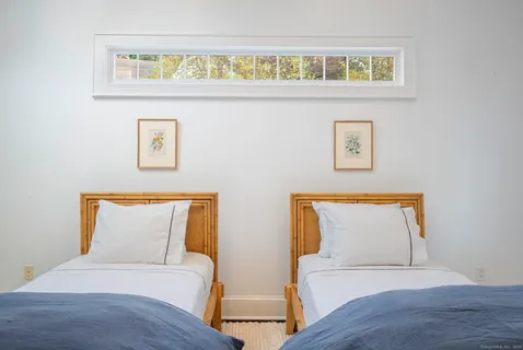 a bedroom with a bed and a painting on the wall