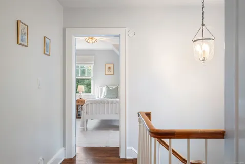 a view of a hallway with wooden floor and dining room