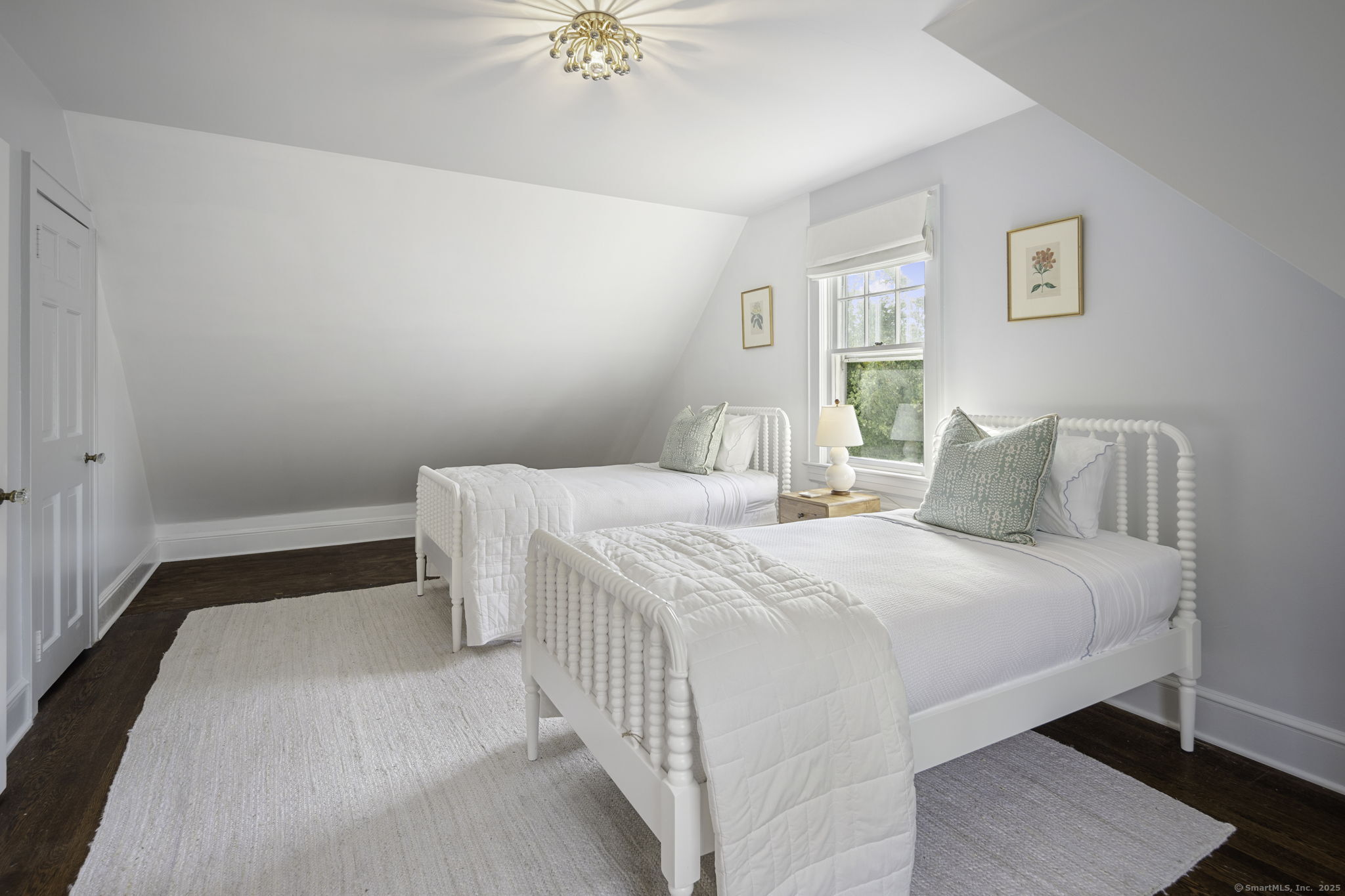 1 Flicker Lane Norwalk, CT 06853 - Photo 27 of 39 a bedroom with a bed and a chandelier