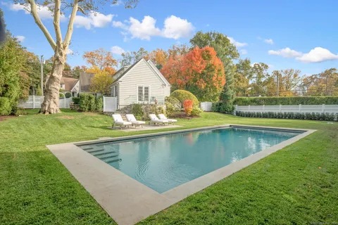 a view of a house with swimming pool and a yard