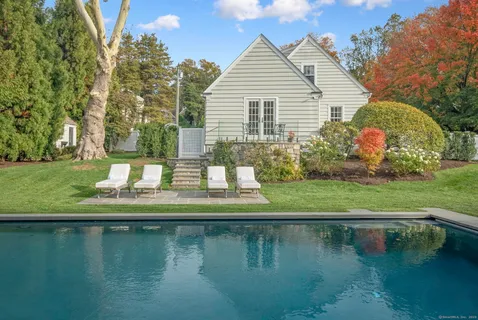 a view of swimming pool with yard and green space