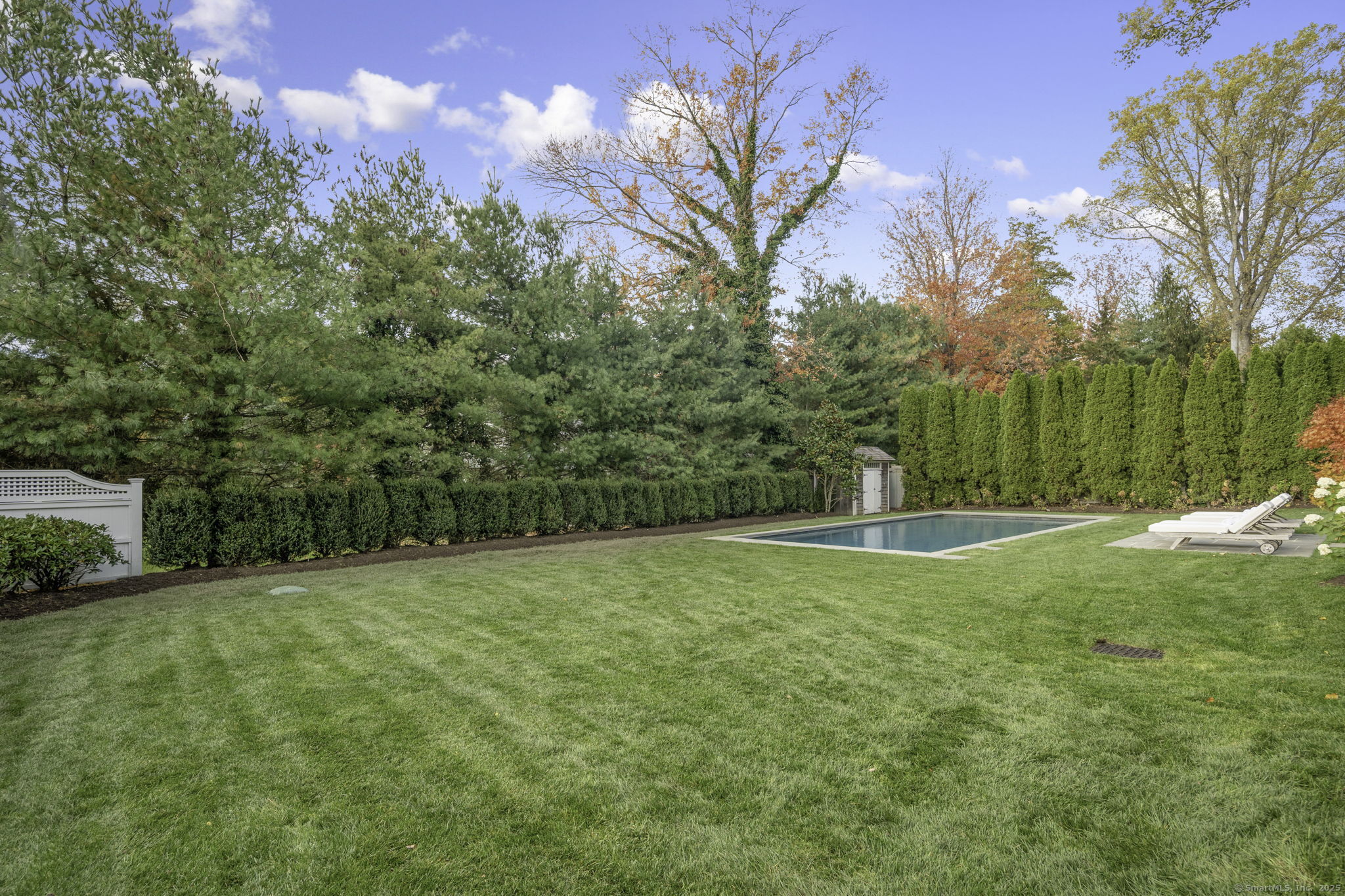 1 Flicker Lane Norwalk, CT 06853 - Photo 37 of 39 a view of a grassy field with trees in the background