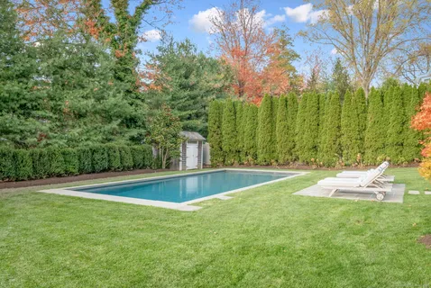 a view of a swimming pool with a yard