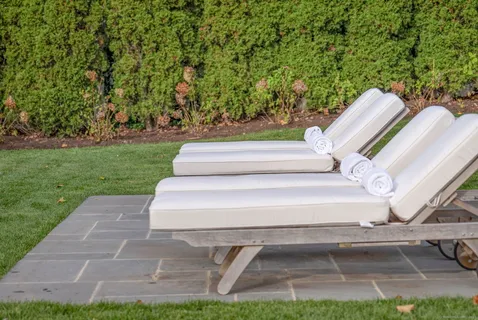 a view of backyard with seating area and trees