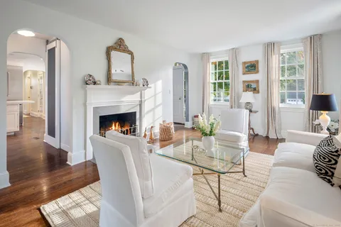 a living room with furniture fireplace and window