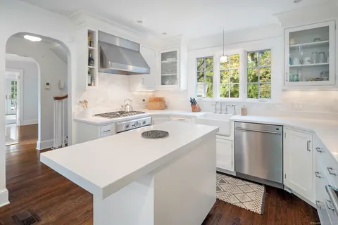a kitchen with a stove a sink and a refrigerator