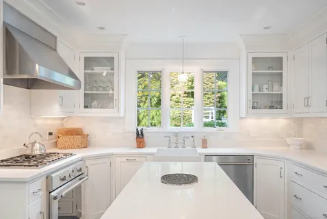 a kitchen with a sink stove and cabinets