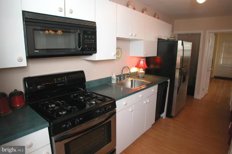 6461 Blenheim Road Baltimore, MD 21212 - Photo 8 of 20 a kitchen with stainless steel appliances granite countertop a stove a refrigerator and a microwave