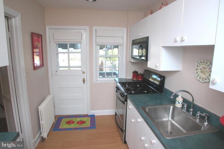 6461 Blenheim Road Baltimore, MD 21212 - Photo 9 of 20 a kitchen with a sink stove top oven and cabinets