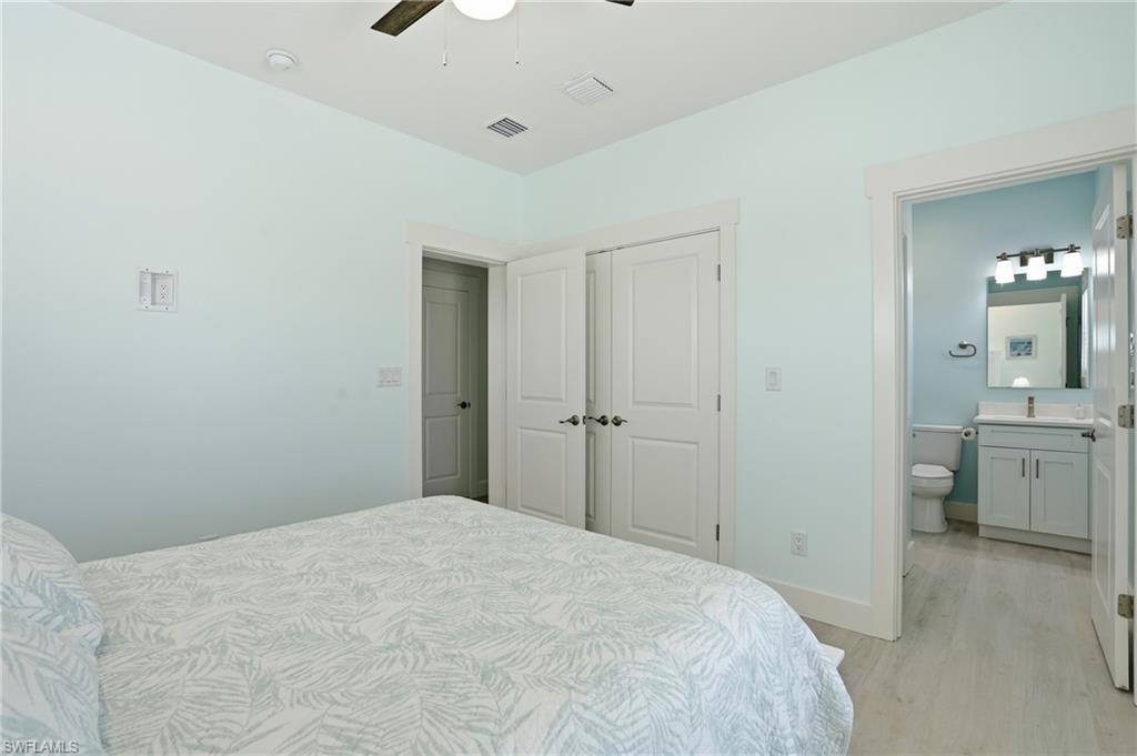 1 Fairview Boulevard Fort Myers Beach, FL 33931 - Photo 16 of 48 a bedroom with a bed and a view of bathroom