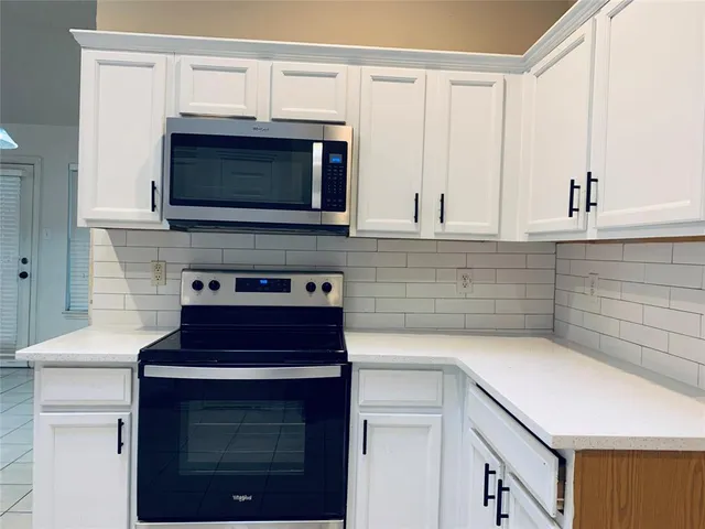 a kitchen with cabinets stainless steel appliances and a sink